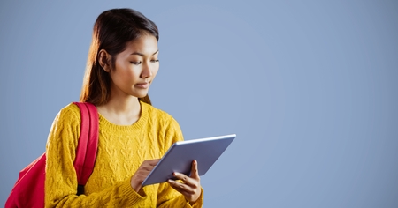 Digital composite of College student with tablet against purple background