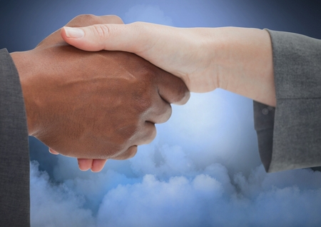 Digital composite of Handshake with cloudy backgroundの写真素材