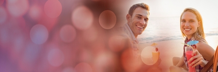Digital composite of Millennial couples having cocktails on beach with red bokeh transitionの写真素材