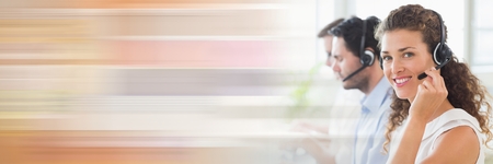 Digital composite of Customer service assistants  with headsets with bright backgroundの写真素材