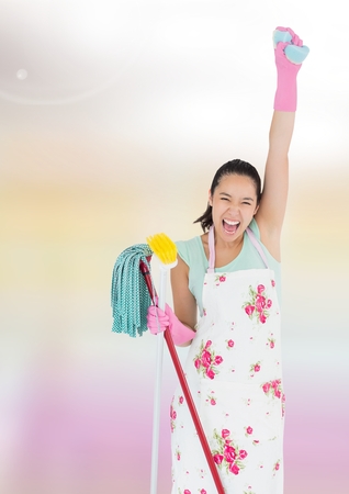 Digital composite of Cleaner joyful and celebrating holding mop with bright backgroundの写真素材