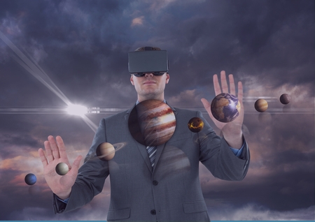 Digital composite of Man in VR headset touching 3D planets against purple sky with clouds and flares