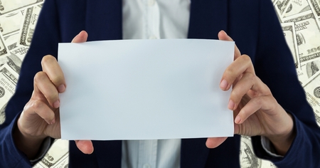 Digital composite of Business woman mid section with blank card against money backdropの写真素材