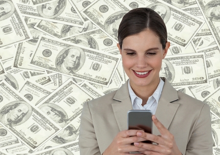 Digital composite of Business woman with phone against money backdropの写真素材
