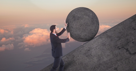 Digital composite of Man pushing 3D rolling round rockの写真素材