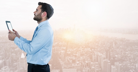 Digital composite of businessman on phone in cityscapeの写真素材