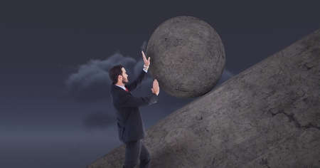 Digital composite of Man pushing rolling round rockの写真素材