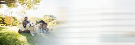 Digital composite of Family lying on grass and blurry white transition 3dの写真素材