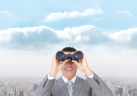 Digital composite of Happy man looking through binoculars against city backgroundの写真素材