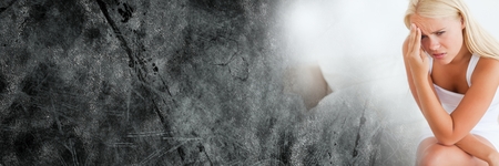 Digital composite of Frustrated woman sitting on bed and grey grunge transitionの写真素材