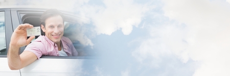 Digital composite of Man  in car holding license card with transitionの写真素材
