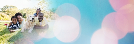 Digital composite of Family lying on grass with blue and pink bokeh transitionの写真素材