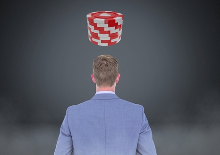 Digital composite of Back of Man Looking at 3d casino poker chipsの写真素材