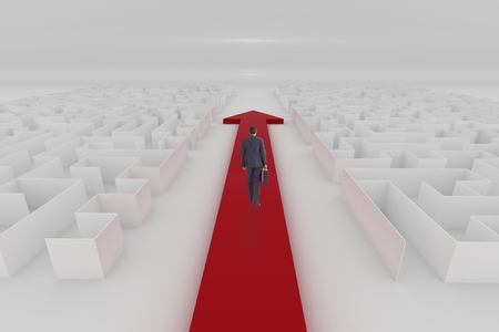 Digital composite of Man walking in a 3D maze with an arrowの写真素材