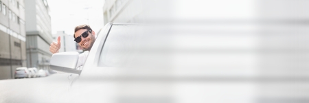 Digital composite of Cool man In car with thumbs up with transitionの写真素材