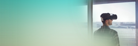 Digital composite of Man looking out window in virtual reality headset with green copy space transitionの写真素材