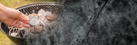 Digital composite of Hand with dial at bbq and grey grunge transitionの写真素材