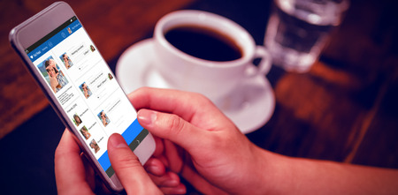 3D interface of chat application against cropped image of man holding smart phoneの写真素材