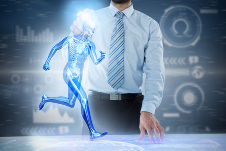 Midsection of businessman touching invisible 3D screen at desk against purple vignetteの写真素材