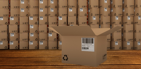 Open cardboard box by stack of boxes against room with brick wallの写真素材