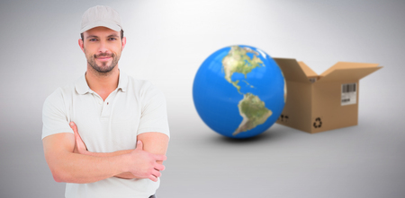 3D image of delivery man standing arms crossed against grey backgroundの写真素材
