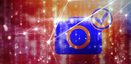 Digital 3D camera with tick symbol against glowing blue backgroundの写真素材
