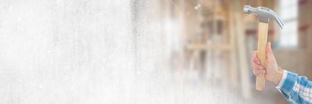 Digital composite of Hand with hammer on building site with transition effectの写真素材