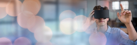 Digital composite of Man Wearing VR Headset with sparkling lights bokeh transitionの写真素材