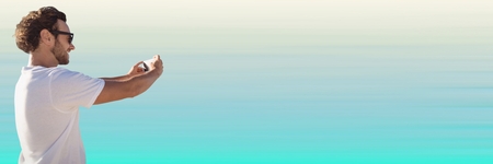 Digital composite of Man white shirt taking selfie against light blue background