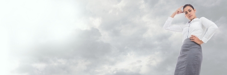 Digital composite of Thinking  businesswoman perspective view with cloudy sky transitionの写真素材