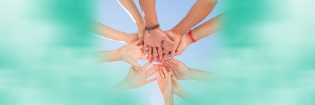 Digital composite of Low angle of hands together and blurry  teal framing