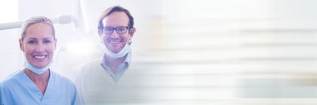 Digital composite of Two dentists smiling and blurry white transitionの写真素材