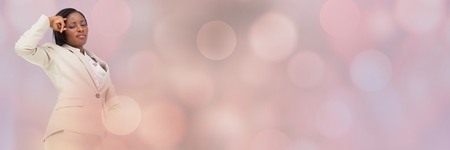Digital composite of Thinking businesswoman with sparkling lights bokeh transitionの写真素材