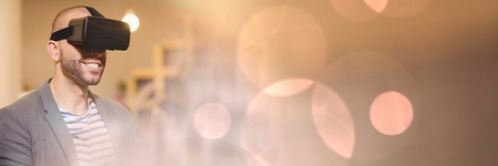Digital composite of Man Wearing VR Headset with sparkling lights bokeh transition