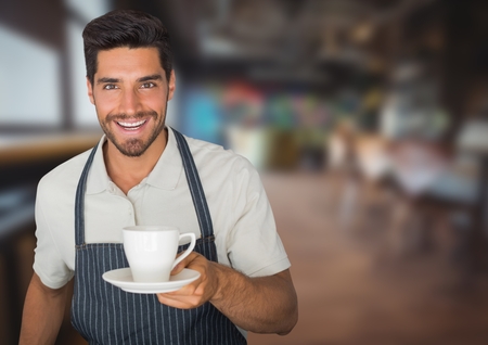 Digital composite of Cafe owner  handing out cup of coffee against blurry cafeの写真素材