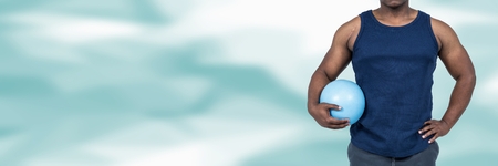 Digital composite of Strong healthy man holding exercise ball