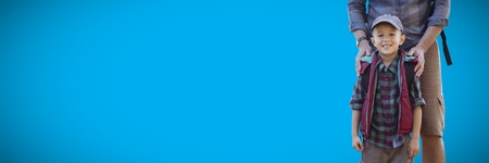 Digital composite of Father hands on son\\\'s shoulders against blue backgroundの写真素材