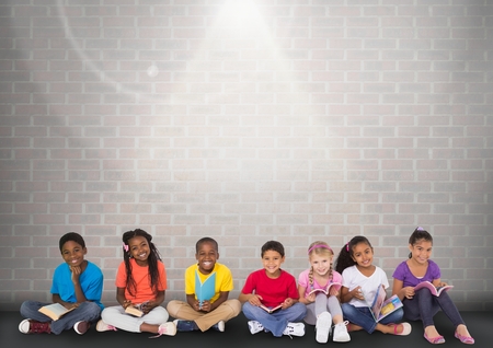 Digital composite of Group of children sitting in front of brick grey backgroundの写真素材
