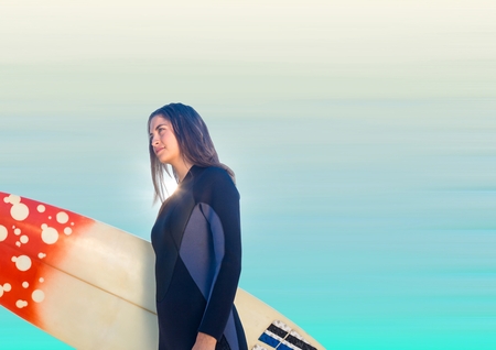 Digital composite of Surfer woman looking to left against blurry blue background