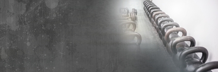 Digital composite of Kettlebells in Gym with grunge transition