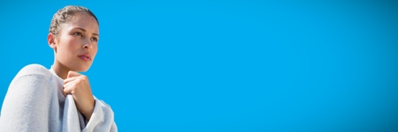 Digital composite of Portraiture of millennial woman against blue backgroundの写真素材