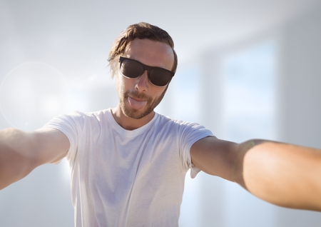 Digital composite of man taking casual selfie photo in front of blurred background