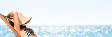 Digital composite of Woman sunbathing against blurry horizonの写真素材