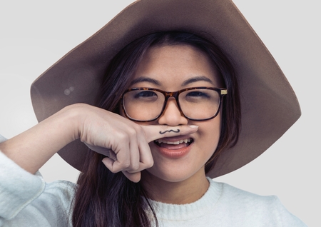 Digital composite of Portrait of woman being silly with grey backgroundの写真素材