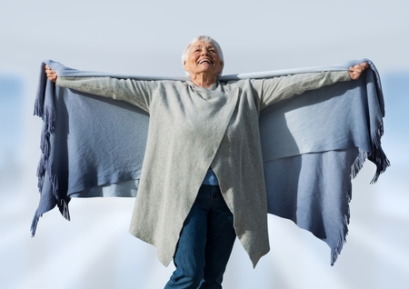 Digital composite of Woman with open arms practicing casual mindfulness in front of skyの写真素材