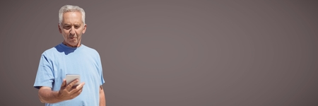 Digital composite of Elderly man texting against brown background