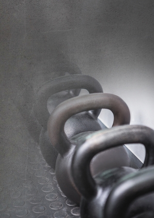 Digital composite of kettlebells in Gym with transitionの写真素材