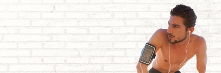 Digital composite of Man tired from training against white brick wallの写真素材