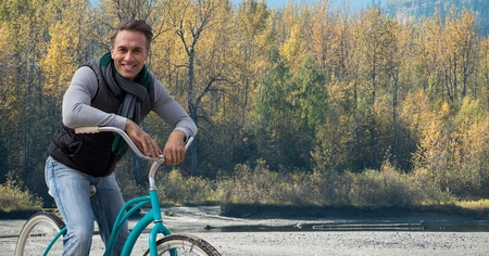 Digital composite of Middle aged man on bicycle against forest