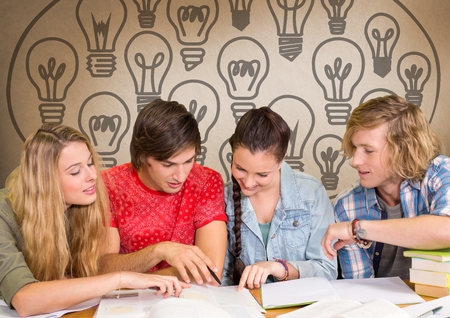 Digital composite of Group of students studying in front of light bulbs graphicsの写真素材